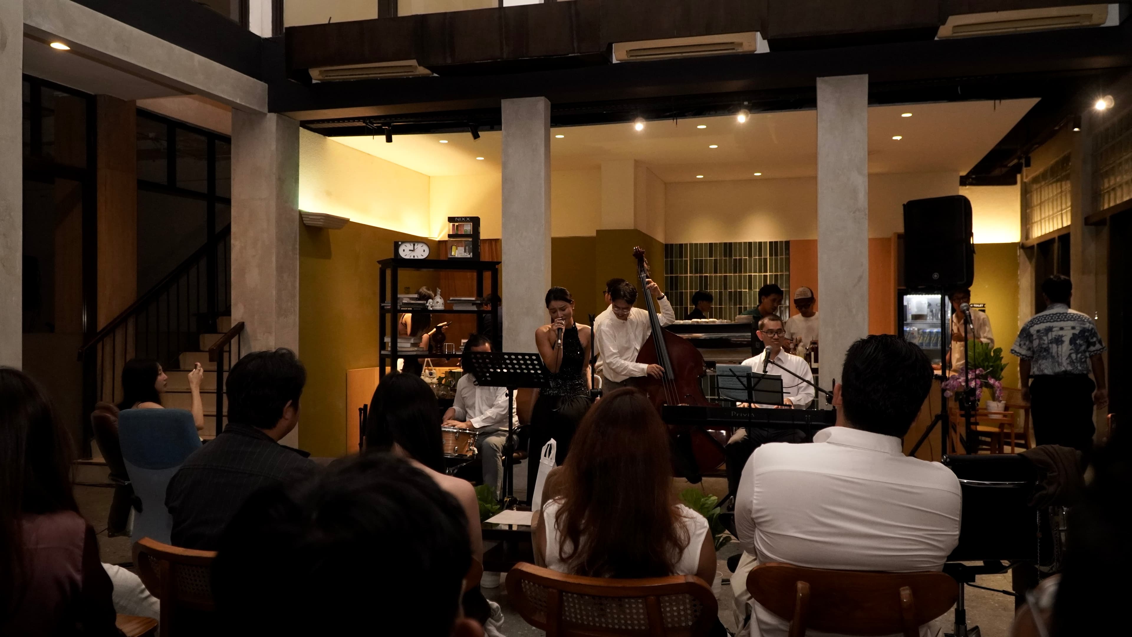 The jazz ensemble performs among guests during Saudade House 52 Volume I in Andara, Jakarta.